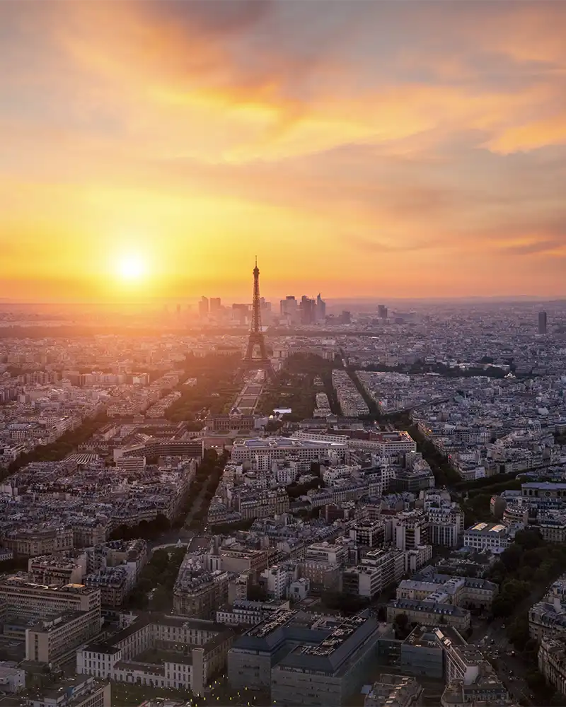 Aerial view, from Montparnasse tower at sunset and night sky, view of the Eiffel Tower and La Defense district in Paris, France